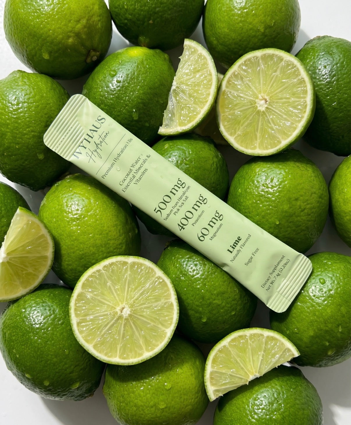 Ivy Haus Lime hydration mix packet on a bed of limes