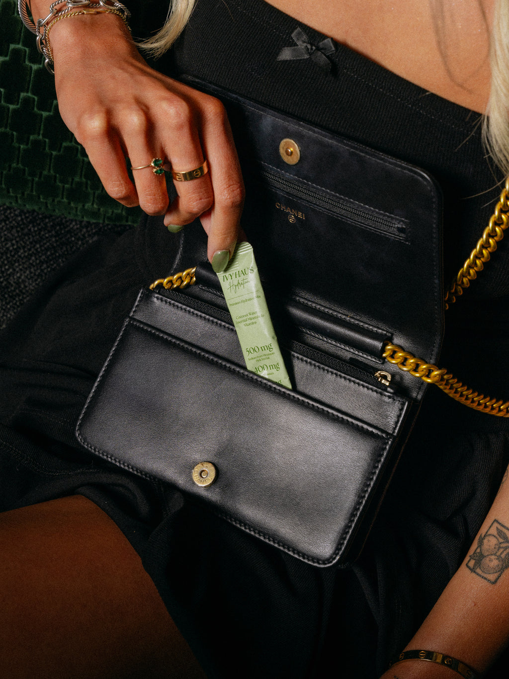 Woman pulling an Ivy Haus Lime hydration packet out of her purse