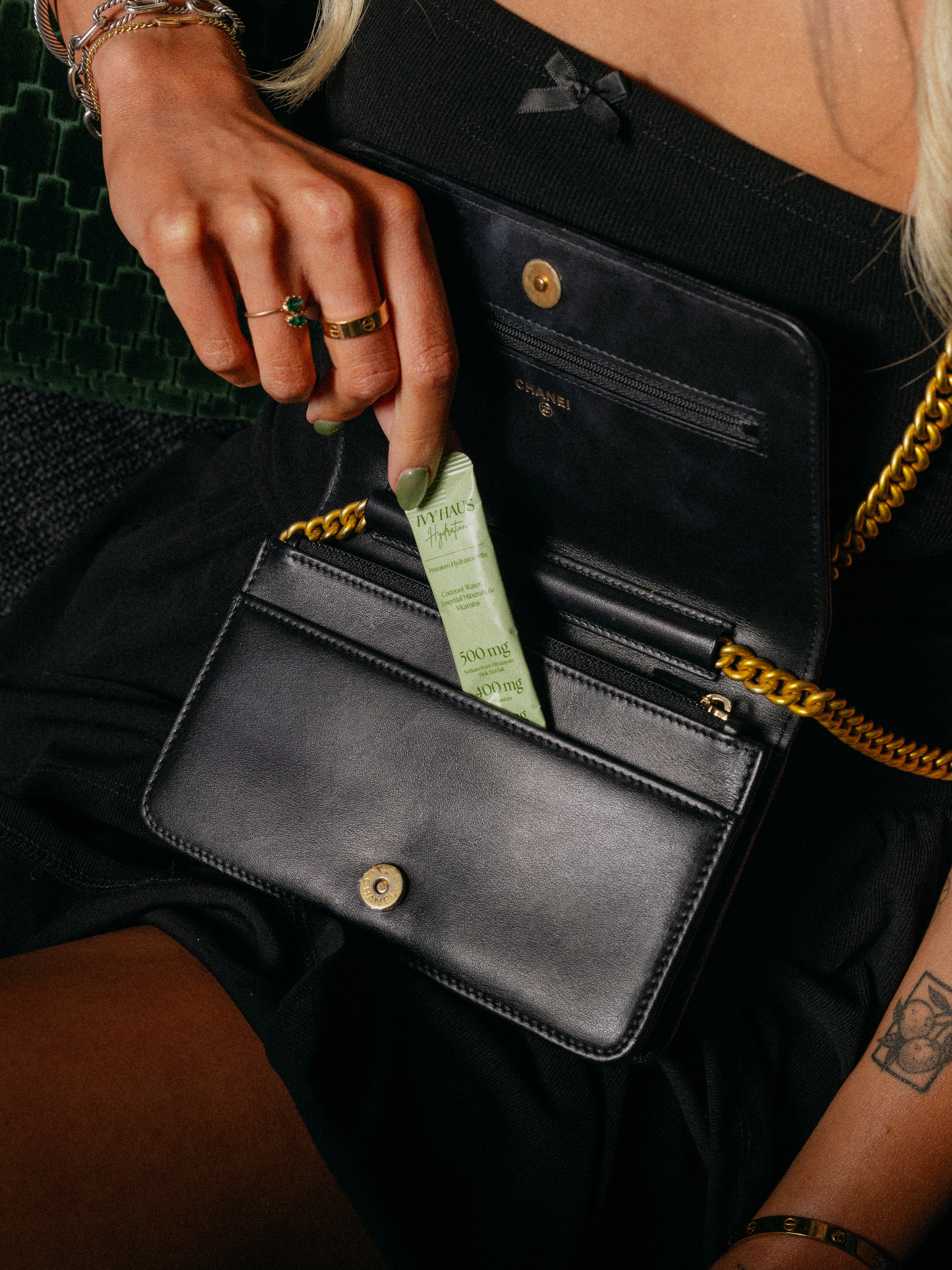Woman pulling an Ivy Haus Lime hydration packet out of her purse